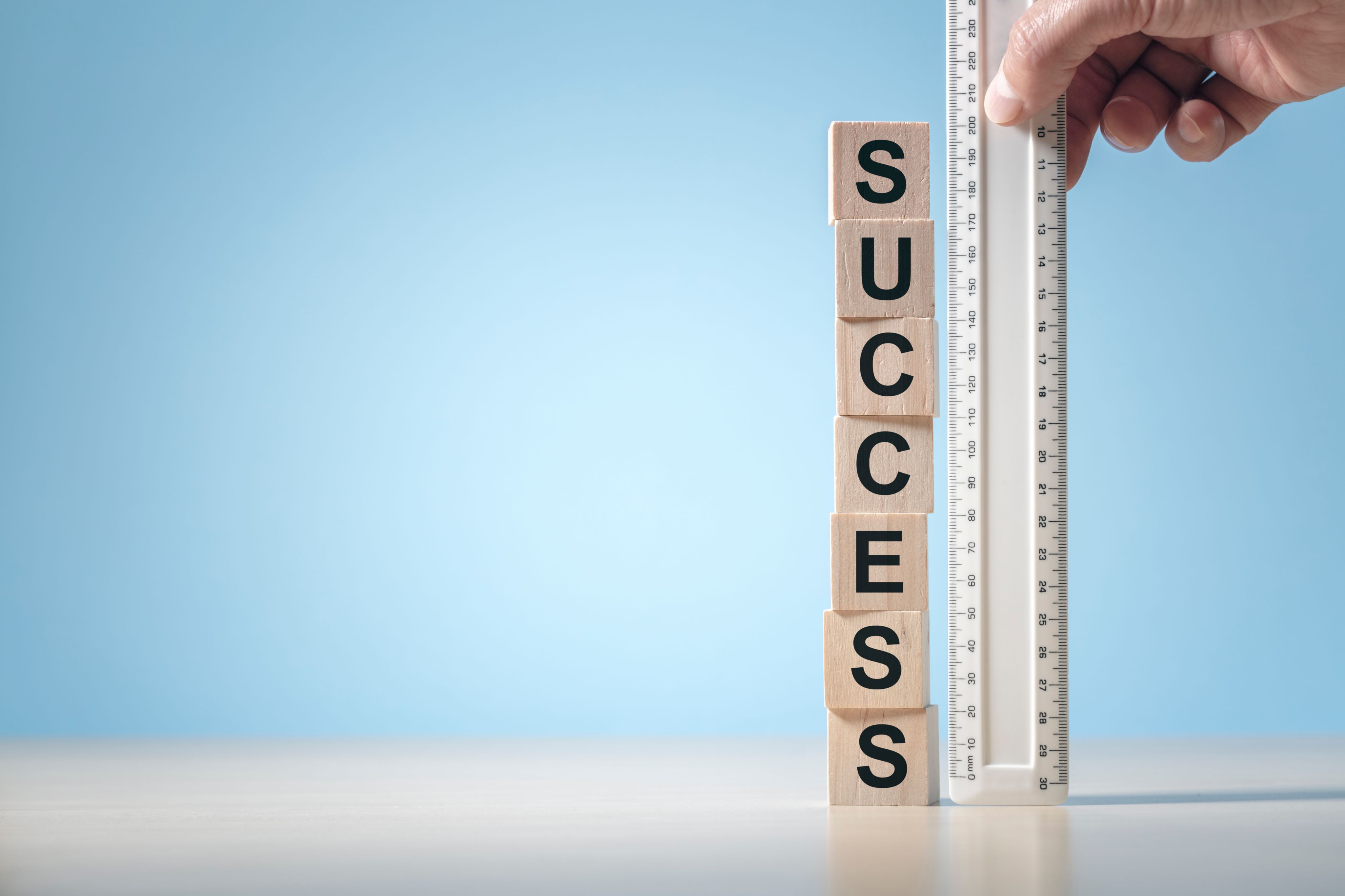 Blocks spelling SUCCESS next to a ruler