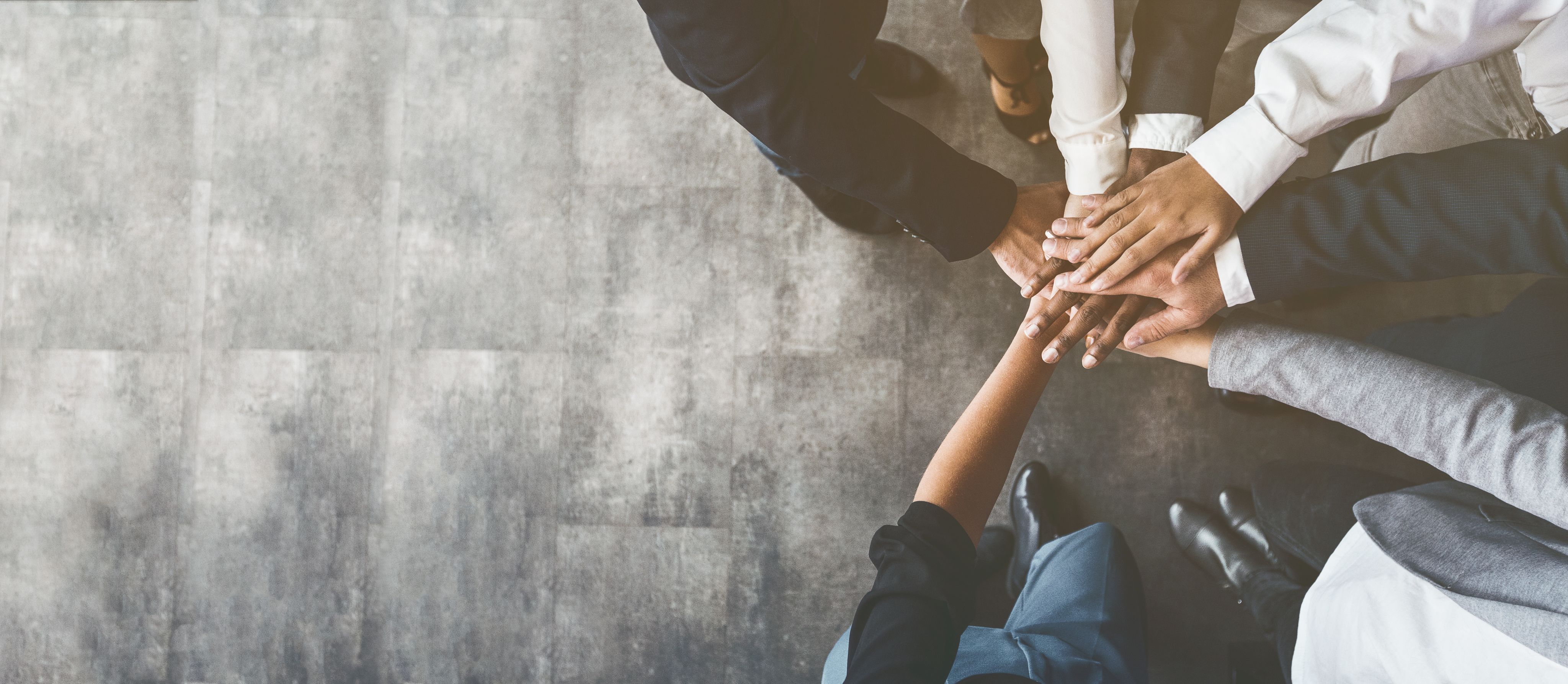 team members joining hands