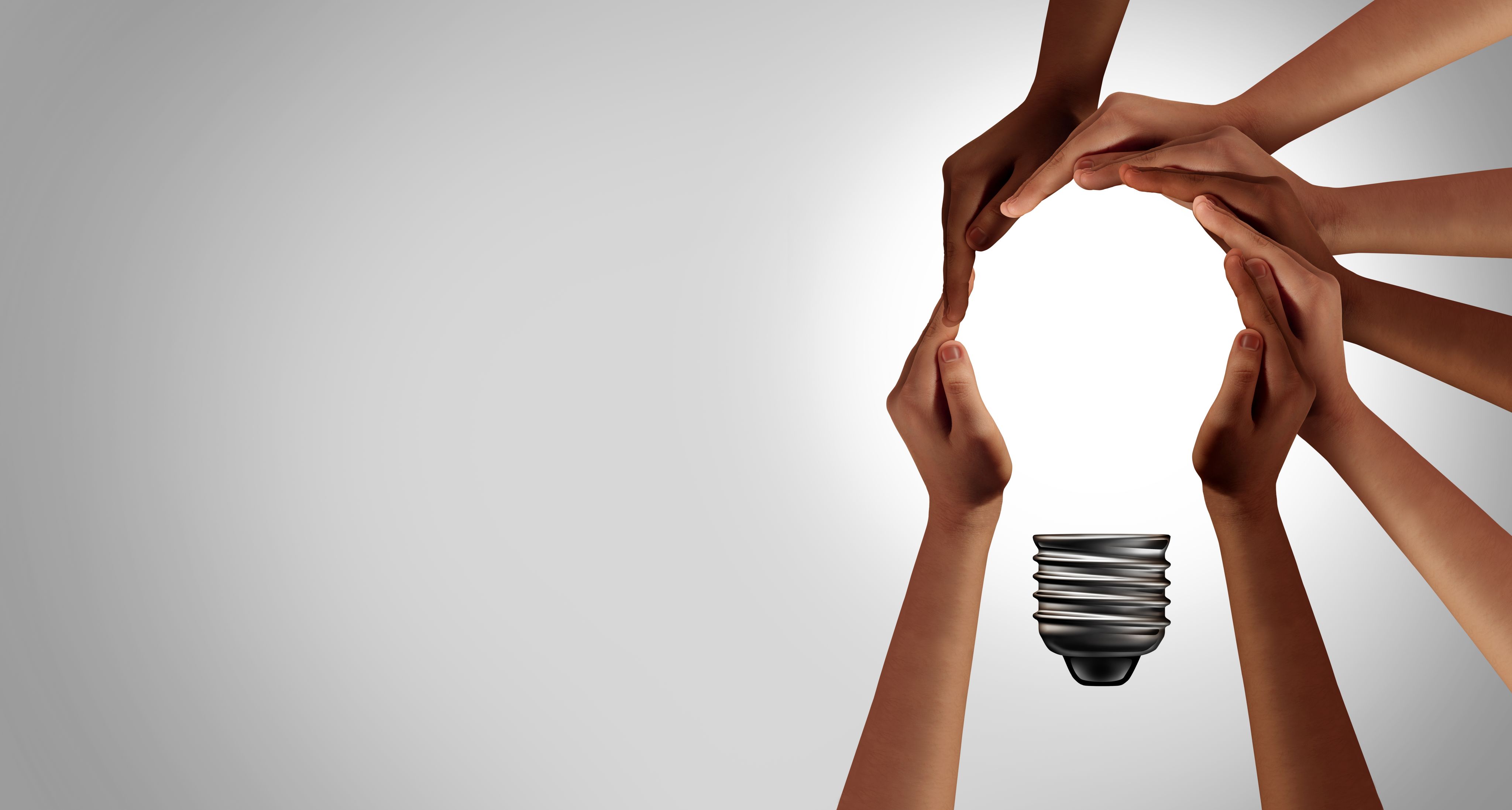 hands joined together forming a light bulb